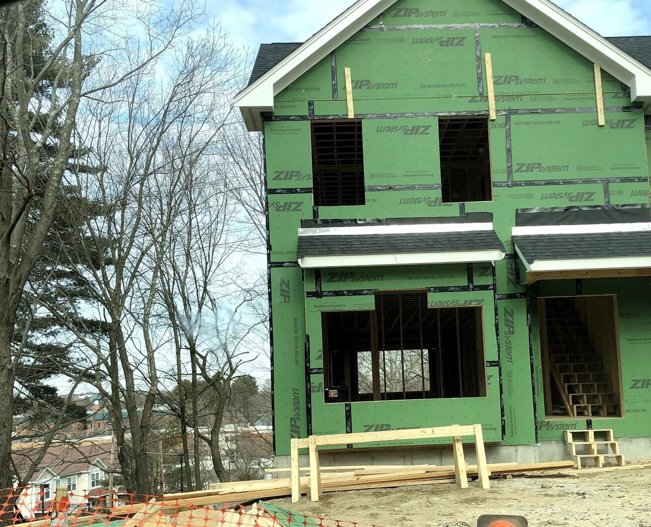 New single-family home under construction with framing and green sheathing
